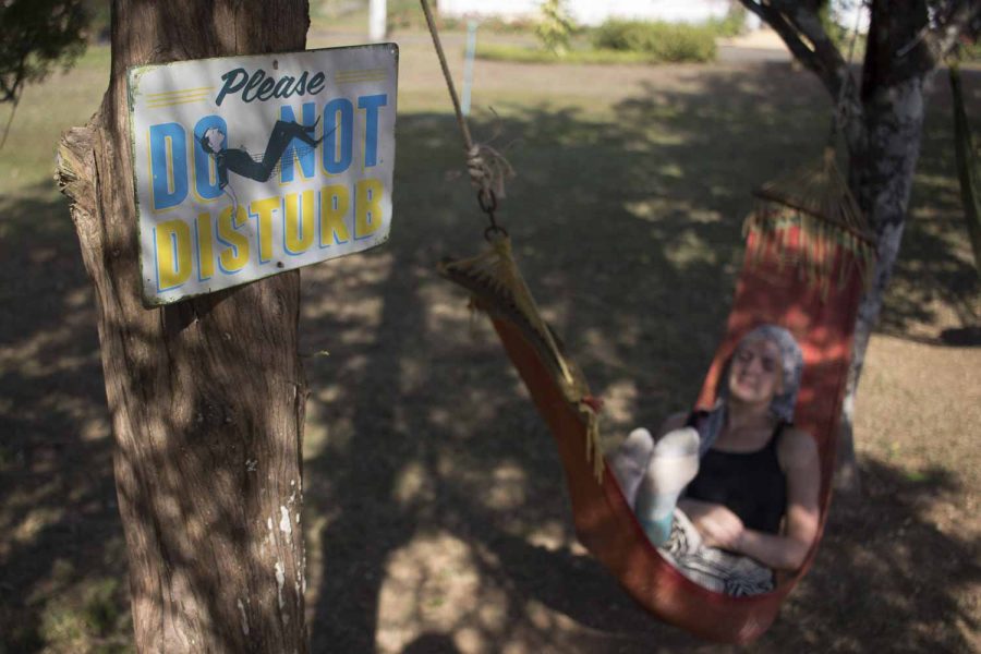 Me lying in a hammock with "do not disturb" sign