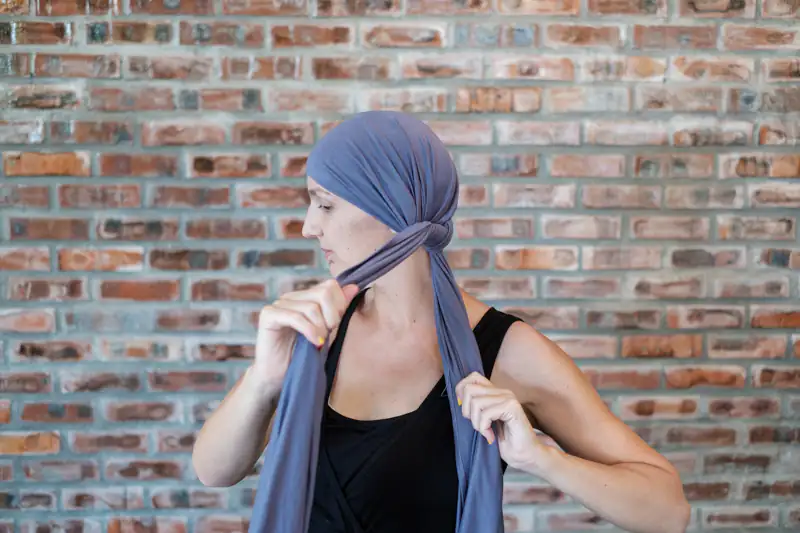 Tying headscarf behind ears