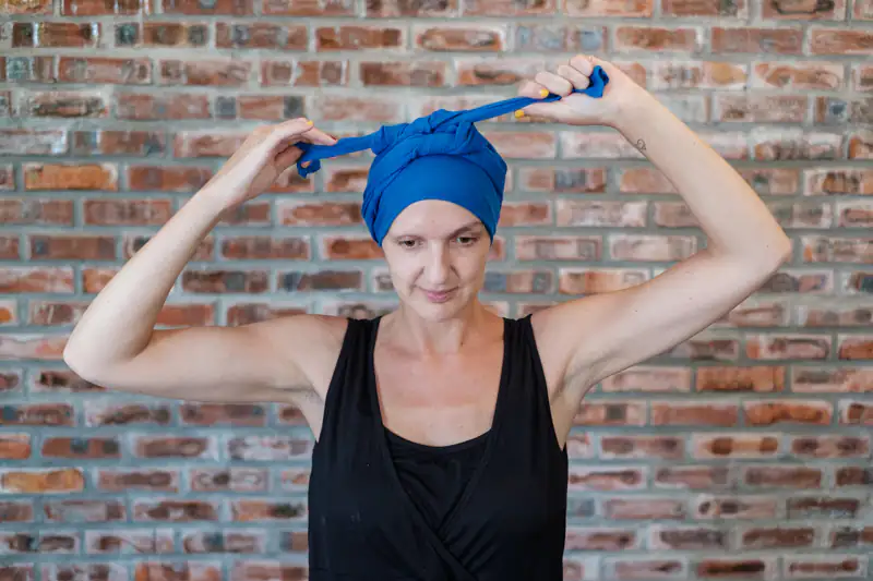 Girl tying headscarf