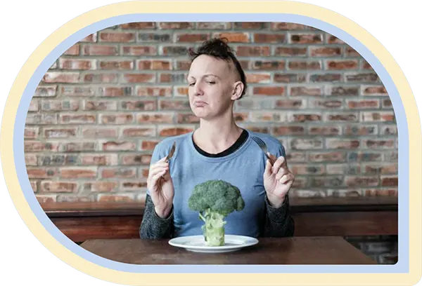 Girl with Alopecia eating brocolli