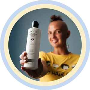 Lady Alopecia with Nioxin Shampoo Bottle