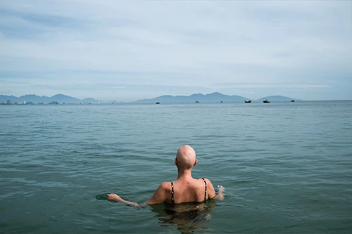 Bald lady in sea